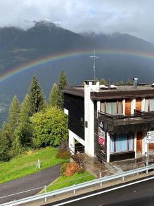 a rainbow over a building with a building at Residence Abete in Marilleva