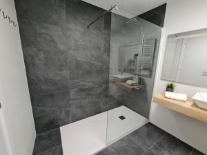 a bathroom with a walk in shower and a sink at Alojamientos Segóbriga Rural ( Mandil) in Segorbe +13 photos