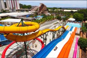 an amusement park with a roller coaster and a water park at Piazza Diroma com acesso Acqua Park e Splash in Caldas Novas