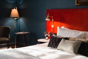 a bedroom with a bed with a red headboard and a chair at Avon Gorge by Hotel du Vin in Bristol +86 photos