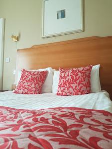 
a white bed with a white comforter and pillows at Great Northern Hotel; Sure Hotel Collection by Best Western in Peterborough
