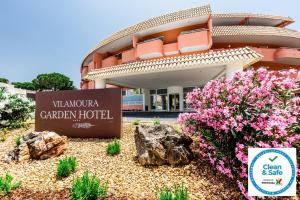 a building with a sign on the side of it at Vilamoura Garden Hotel in Vilamoura