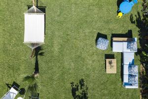 an overhead view of a lawn with tables and chairs at Lagoon Seaside Villa, Sumptuous Retreat,By ThinkVilla in Panormos Rethymno +50 photos