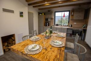a wooden table in a kitchen with a dining room at Vila Harmónia in Lúčka +27 photos