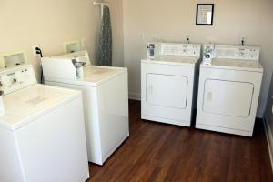 a laundry room with two washes and two dryers at Affordable Suites Shelby in Shelby