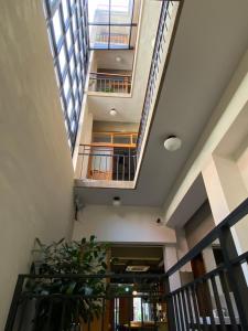 a staircase in a building with skylights and a plant at De Provintia Straat B&B in Tainan