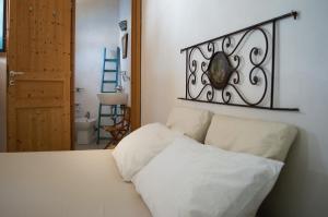 a bed with two pillows on it in a room at Casa Artemisia in Filicudi