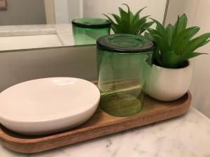 a bowl and a jar on a cutting board with a plant at Appartement Le Cosi 2 -bord de mer- in La Ciotat