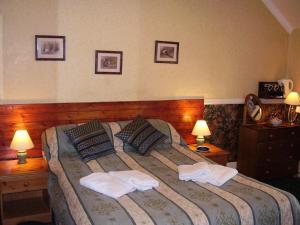 a bedroom with a large bed with towels on it at Weybourne Guest House in Tenby