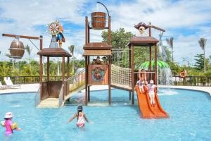 
two children are playing in a pool on a raft at Grand Sunset Princess - All Inclusive in Playa del Carmen
