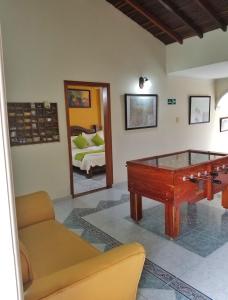 a living room with a pool table and a bed at Sam'S VIP Hostel San Gil in San Gil