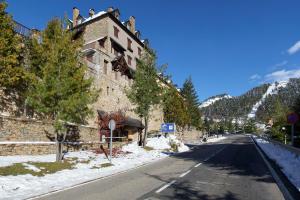 an empty street next to a building in the mountains at Pujolo by FeelFree Rentals in Naut Aran