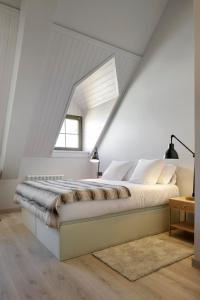 a bedroom with a large bed in a attic at Pujolo by FeelFree Rentals in Naut Aran