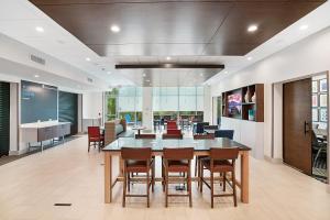 an office lobby with a large table and chairs at Holiday Inn Express - Jacksonville South Bartram Prk by IHG in Jacksonville