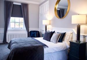 a bedroom with a large bed and a large mirror at J.D.Young in Harleston