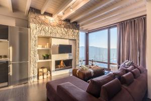 a living room with a couch and a fireplace at White Hills Villas in Arachova