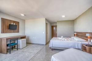 Tempat tidur dalam kamar di Happy Hotel Pajuçara