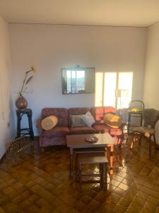 a living room with a couch and a table at Friuli Appartamenti in Cormòns