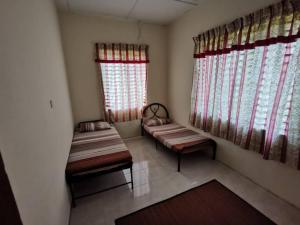 a small room with two benches and two windows at Villa Pulai Indah Temerloh in Temerloh