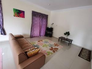 a living room with a couch and a rug at Villa Pulai Indah Temerloh in Temerloh