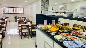 a buffet line with food on display in a restaurant at Hotel Praça da Árvore - São Paulo Expo in São Paulo