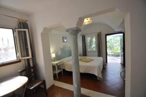 a bedroom with a bed and a column in it at Villa Eva in Anacapri