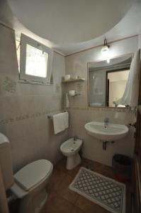 a bathroom with a toilet and a sink at Villa Eva in Anacapri