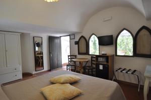 a bedroom with a bed with two pillows on it at Villa Eva in Anacapri