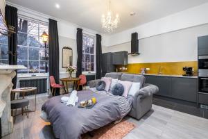 a living room with a couch and a kitchen at King Square Serviced Apartments in Bridgwater