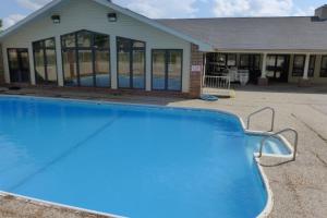 a swimming pool in front of a house at Foothill's Luxury 2BDR Ground Floor Condo in 1000 Hill's in Branson