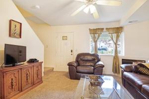 a living room with leather furniture and a tv at Harbor Village Lakeview Condo 902-3 in Garden City