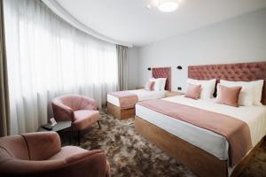 Postel nebo postele na pokoji v ubytování Hotel Barcode Wellness & Spa