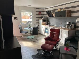 a living room with a kitchen with a table and chairs at Haus-Encore-Wohnung-3 in Büsum