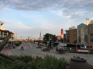 a man walking down a street next to a river at Haus-Encore-Wohnung-3 in Büsum