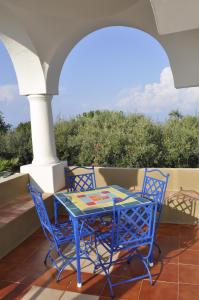 a blue table and chairs on a patio at Villa Eva in Anacapri
