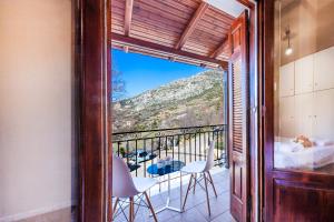 a balcony with a view of a table and chairs at White Apartments by White Hills in Arachova