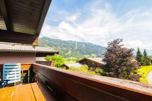 a balcony of a house with a view of the mountains at Apartment Schmid - Steinbock Lodges in Maishofen