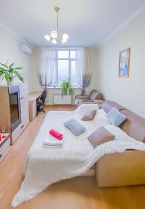 a bedroom with a large bed with towels on it at Rent Kiev Apartment 2 min metro Chernihivska in Kyiv