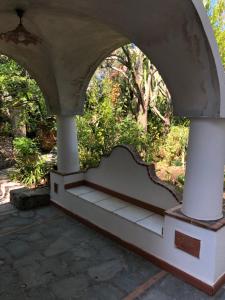 an archway with a bench in a garden at Villa Eva in Anacapri