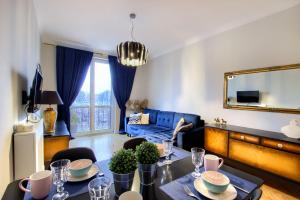 a living room with a table and a couch at Katarzyny11 in Toruń