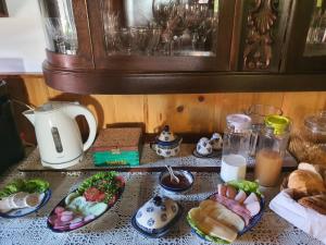 a table topped with plates of food on a counter at Siedlisko nad Sapiną in Kruklanki