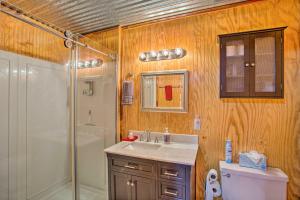 a bathroom with a shower and a sink and a toilet at Cozy Cottage on Lake O The Pines with Lake Views! in Avinger +20 photos