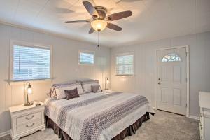 a bedroom with a bed and a ceiling fan at Cozy Cottage on Lake O The Pines with Lake Views! in Avinger