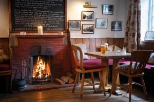 a fireplace in a restaurant with a table and a fire place at The White Horse Inn in York