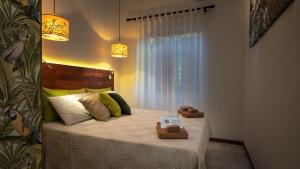 a small bedroom with a bed with a window at Relais Casa Moresca in Terracina