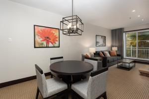 a living room with a table and chairs and a couch at Ermitage du Lac in Mont-Tremblant