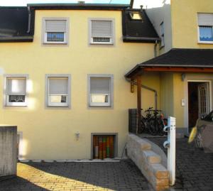 a yellow house with bikes parked in front of it at Ferienwohnung-Thielen-Waldrach-Ruwertal in Waldrach
