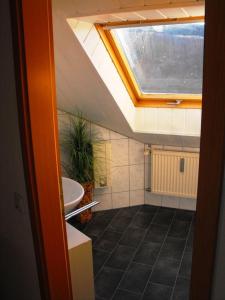 a bathroom with a sink and a skylight at Ferienwohnung-Thielen-Waldrach-Ruwertal in Waldrach