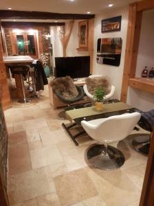 a living room with a table and chairs and a couch at Le Havre de paix in Saint-Dalmas-le-Selvage