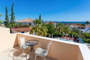a view of a balcony with chairs and a table at Vanas Apartments in Spetses